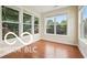 Bright sunroom with hardwood floors, and multiple windows which provide lots of natural light and views of the surrounding greenery at 19146 Carol Cove Cir, Noblesville, IN 46062