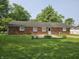 The house features a simple backyard and has a brick exterior with several windows that offer views at 2017 Schwier Ct, Indianapolis, IN 46229