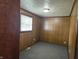 Basement with wood paneling and a window with blinds at 2017 Schwier Ct, Indianapolis, IN 46229