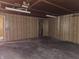 Unfinished basement with paneled walls and concrete floor, offering potential for various uses at 2017 Schwier Ct, Indianapolis, IN 46229