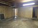 Unfinished basement space ready for customization, with concrete flooring and wood paneled walls at 2017 Schwier Ct, Indianapolis, IN 46229