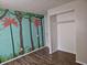 Bedroom with tree mural on the wall and wood floors at 2017 Schwier Ct, Indianapolis, IN 46229