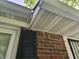 A close exterior shot of white eaves and brick wall with dark shutter on the side of the house at 2017 Schwier Ct, Indianapolis, IN 46229