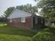 Charming brick home with white siding, a covered front porch and a well-maintained lawn at 2017 Schwier Ct, Indianapolis, IN 46229