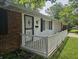 Home showing the front porch with white railing, brick exterior, and decorative iron security door at 2017 Schwier Ct, Indianapolis, IN 46229