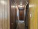 Hallway with paneled wood, neutral carpet, and access to the bedrooms at 2017 Schwier Ct, Indianapolis, IN 46229