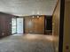 Spacious living room featuring neutral carpet, wood paneled walls, and a front door entrance at 2017 Schwier Ct, Indianapolis, IN 46229