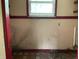 A room in need of renovation with stained walls and baseboards at 206 E Hurdle Rd, Morgantown, IN 46160