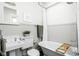 Classic bathroom features a vintage tub, pedestal sink and beadboard paneling at 2158 S Garfield Dr, Indianapolis, IN 46203