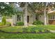 Charming home with mature trees and landscaped front yard and a pathway leading to the front door at 2158 S Garfield Dr, Indianapolis, IN 46203