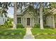 Charming home with mature trees and landscaped front yard and a pathway leading to the front door at 2158 S Garfield Dr, Indianapolis, IN 46203