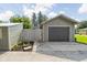 Spacious detached garage with a large driveway and access to a fenced backyard at 2158 S Garfield Dr, Indianapolis, IN 46203