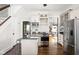 Bright kitchen with stainless steel appliances, granite countertops, and hardwood floors at 2158 S Garfield Dr, Indianapolis, IN 46203
