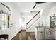 Spacious living room with hardwood floors, a staircase, and a sink at 2158 S Garfield Dr, Indianapolis, IN 46203