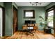 Stylish home office featuring green walls, hardwood floors, and modern desk setup at 2158 S Garfield Dr, Indianapolis, IN 46203