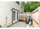 Fenced-in backyard featuring siding, a double patio door, a grill, and some greenery offering a compact outdoor space at 2433 Hideaway S Dr, Indianapolis, IN 46268