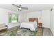 Bright bedroom features a ceiling fan, a large window, and decor rugs at 2433 Hideaway S Dr, Indianapolis, IN 46268