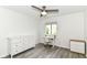 Bedroom featuring a ceiling fan, gray wood-look flooring, and a window with natural light, plus two dressers at 2433 Hideaway S Dr, Indianapolis, IN 46268