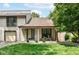 Charming townhome exterior featuring a cozy front patio and lush green lawn at 2433 Hideaway S Dr, Indianapolis, IN 46268