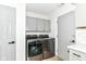 Laundry room with washer and dryer, gray cabinets and modern finishes at 2433 Hideaway S Dr, Indianapolis, IN 46268