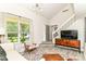 Bright living room featuring a window, a staircase, and a media cabinet, creating a welcoming atmosphere at 2433 Hideaway S Dr, Indianapolis, IN 46268