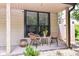 Cozy patio space with wicker chairs, a small table, and potted plants, creating a relaxing outdoor seating area at 2433 Hideaway S Dr, Indianapolis, IN 46268