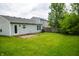Spacious backyard with lush green grass, patio and partial fencing at 2434 Harvest Moon Dr, Greenwood, IN 46143