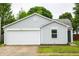 Charming single-story home featuring a one-car garage, light gray siding, and lush landscaping at 2434 Harvest Moon Dr, Greenwood, IN 46143