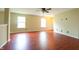 Inviting living room featuring plush carpeting, bright windows, and a modern ceiling fan at 2434 Harvest Moon Dr, Greenwood, IN 46143
