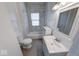 This bathroom has grey tile backsplash, a bathtub, and a white vanity at 244 W 31St St, Indianapolis, IN 46208