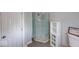 Bathroom featuring a glass shower stall, storage cabinet, and neutral color scheme at 244 W 31St St, Indianapolis, IN 46208
