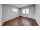 Bedroom featuring wood floors, light-colored walls, and large windows at 244 W 31St St, Indianapolis, IN 46208