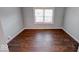 This cozy bedroom has wood floors and a window to let in natural light at 244 W 31St St, Indianapolis, IN 46208