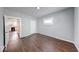 Bedroom featuring wood floors and a view of an updated kitchen through the doorway at 244 W 31St St, Indianapolis, IN 46208