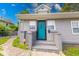 Charming home featuring a bright blue front door and gray brick porch at 244 W 31St St, Indianapolis, IN 46208