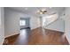 Spacious living room with hardwood floors, a ceiling fan, and access to multiple areas at 244 W 31St St, Indianapolis, IN 46208