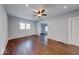 Bright living room features hardwood floors, ceiling fan, and ample natural light from windows at 244 W 31St St, Indianapolis, IN 46208