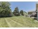 Lush backyard with manicured lawn featuring a hot tub and patio set, creating a peaceful outdoor retreat at 2502 Colinbrook Pkwy, Greenwood, IN 46143
