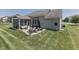 Exterior showcasing screened in porch, hot tub, and patio set amidst a well-manicured lawn at 2502 Colinbrook Pkwy, Greenwood, IN 46143