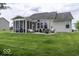 The spacious backyard leads to a home that features a stone patio and a screened-in back porch at 2502 Colinbrook Pkwy, Greenwood, IN 46143