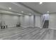 Basement features luxury vinyl flooring, neutral walls, recessed lighting and staircase at 2502 Colinbrook Pkwy, Greenwood, IN 46143