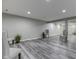 Basement with new luxury vinyl flooring and neutral paint tones, illuminated by recessed lighting at 2502 Colinbrook Pkwy, Greenwood, IN 46143