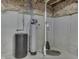 Water softener and tank on concrete basement floor with white insulated walls and exposed piping at 2502 Colinbrook Pkwy, Greenwood, IN 46143