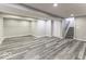Spacious basement area with plank flooring, neutral paint, and stairs at 2502 Colinbrook Pkwy, Greenwood, IN 46143