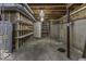 The unfinished basement contains storage shelves and exposed ducts at 2502 Colinbrook Pkwy, Greenwood, IN 46143