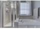 A luxurious bathroom with a soaking tub, separate shower, and elegant chandelier at 2502 Colinbrook Pkwy, Greenwood, IN 46143