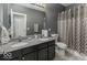 Bathroom featuring a double sink vanity, granite countertops, and a shower with patterned curtain at 2502 Colinbrook Pkwy, Greenwood, IN 46143