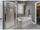 Bathroom featuring a luxurious soaking tub, glass-enclosed shower, and modern fixtures at 2502 Colinbrook Pkwy, Greenwood, IN 46143