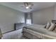 A cozy bedroom with carpet, dresser, large window and a ceiling fan at 2502 Colinbrook Pkwy, Greenwood, IN 46143
