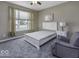 This bedroom features a serene decor with carpet floors, a ceiling fan, and a white paneled bed frame at 2502 Colinbrook Pkwy, Greenwood, IN 46143